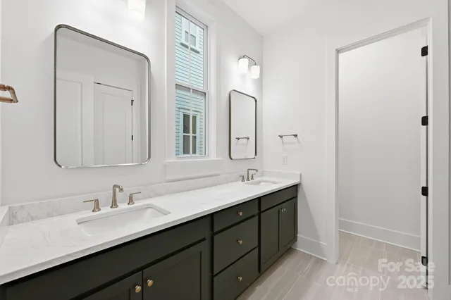 a bathroom with a double vanity sink and mirror