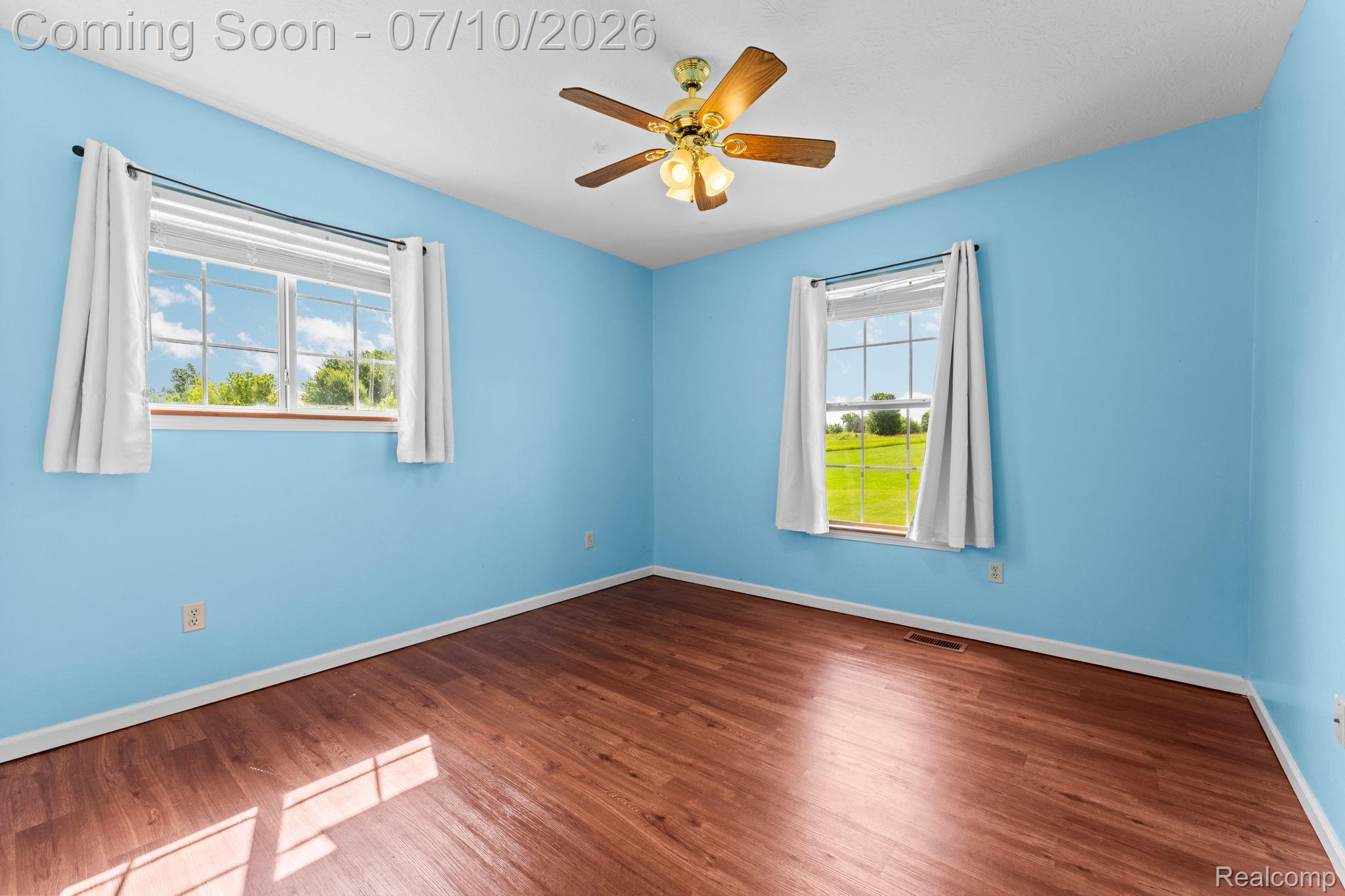 3144 North Nicholson Road Fowlerville, MI 48836 - Photo 47 of 70 Room featuring bright blue walls and rich wood-finish flooring