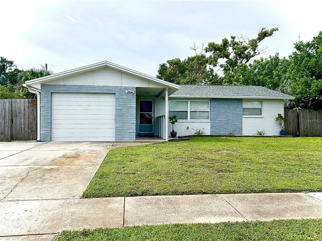 a front view of house with yard and trees