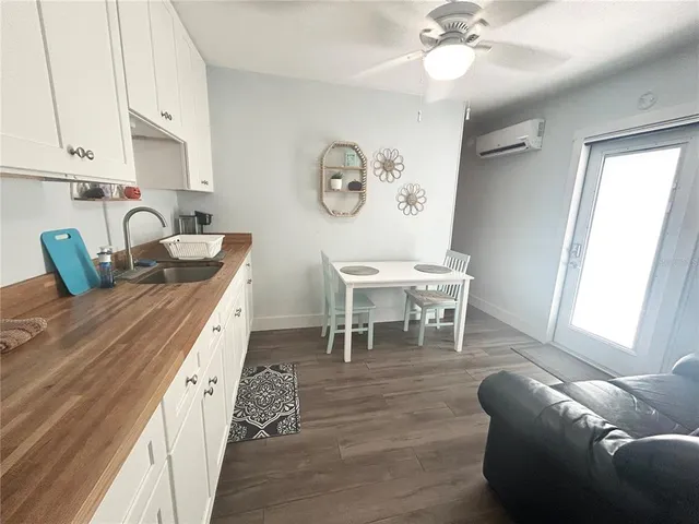 a dining room with wooden floor and a chandelier