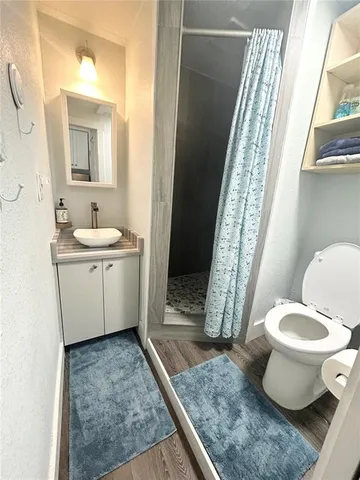 a bathroom with a sink toilet and shower