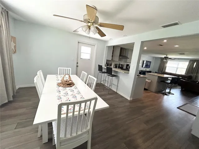 a view of a dining room with furniture and wooden floor