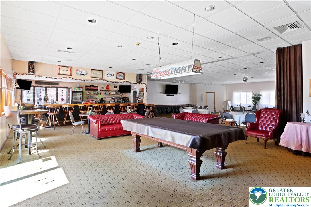 214 Mockingbird Court Bushkill, PA 18324 - Photo 32 of 40 a living room with furniture gym equipment and a rug