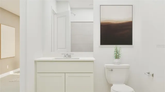 a bathroom with a sink toilet and mirror