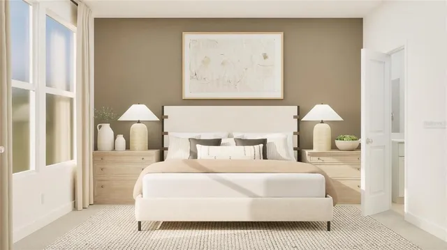 a bedroom with a bed and a painting on the wall