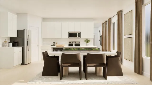 a dining hall with stainless steel appliances granite countertop a dining table and chairs