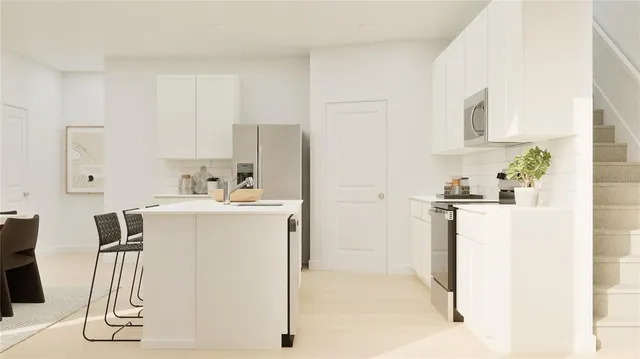 a utility room with cabinets washer and dryer