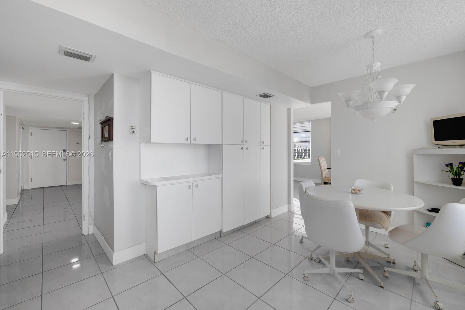 231 174th Street, Unit 2018 Sunny Isles Beach, FL 33160 - Photo 11 of 25 a view of a kitchen and dining room