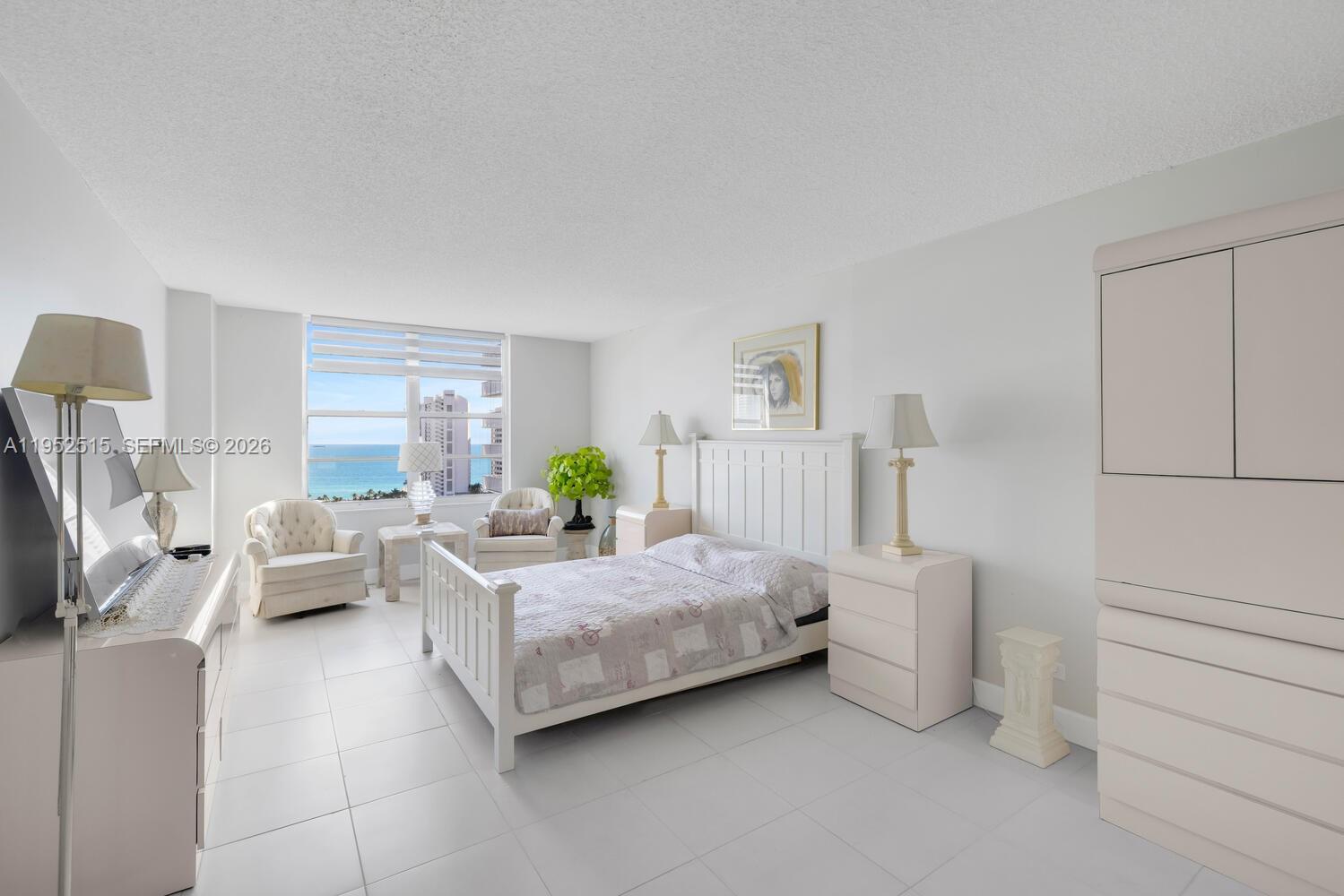 231 174th Street, Unit 2018 Sunny Isles Beach, FL 33160 - Photo 13 of 25 a bedroom with a bed and a couch