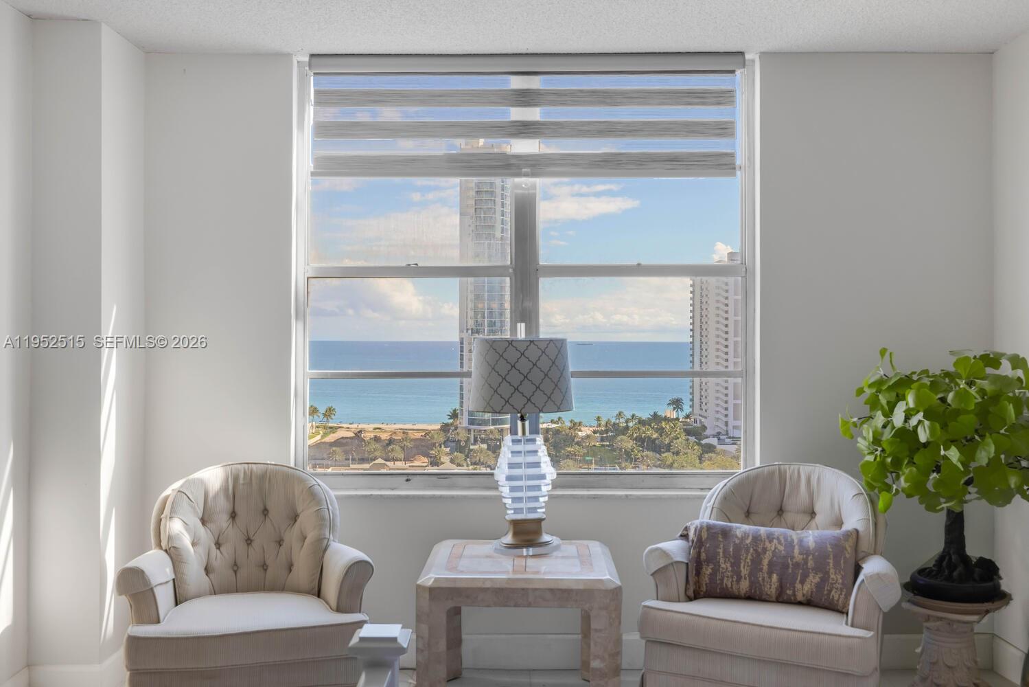 231 174th Street, Unit 2018 Sunny Isles Beach, FL 33160 - Photo 14 of 25 a living room with furniture and a potted plant