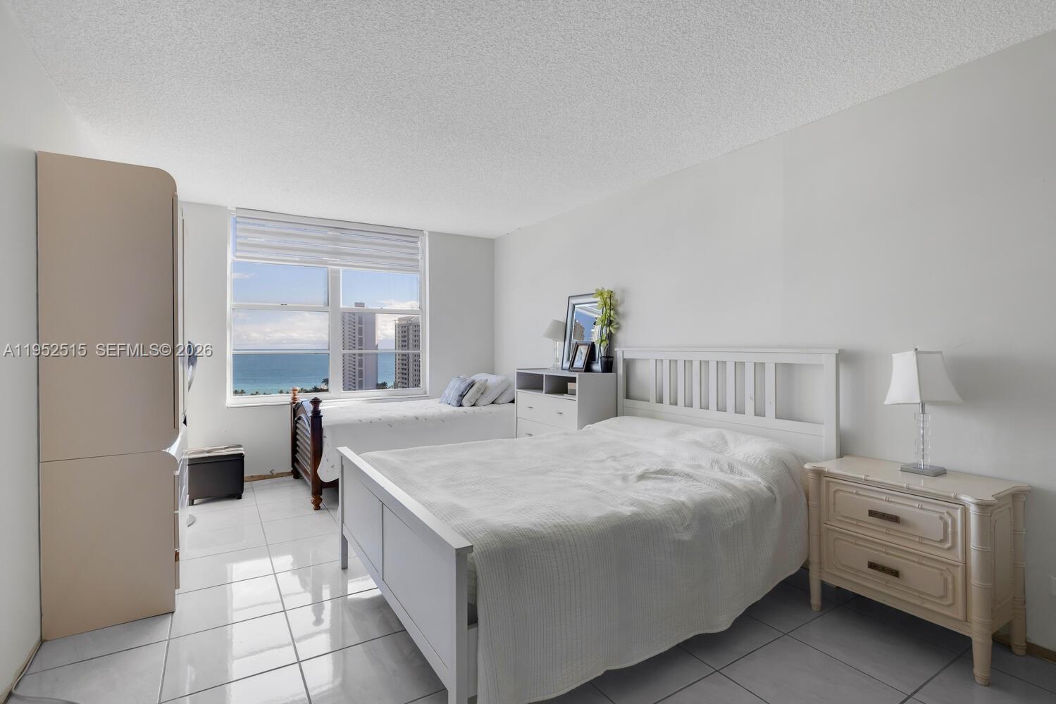 231 174th Street, Unit 2018 Sunny Isles Beach, FL 33160 - Photo 17 of 25 a bedroom with a bed and a large window