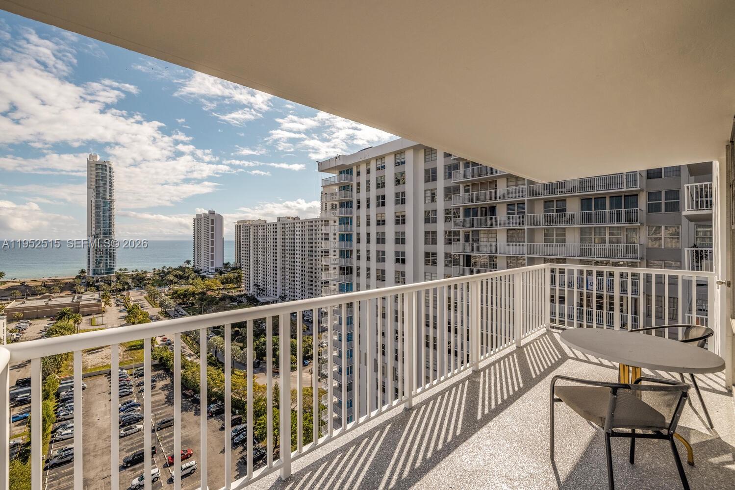231 174th Street, Unit 2018 Sunny Isles Beach, FL 33160 - Photo 22 of 25 a view of balcony with two chairs and wooden fence