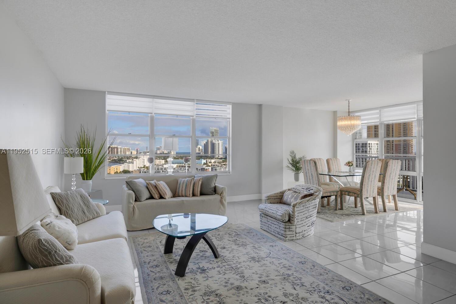 231 174th Street, Unit 2018 Sunny Isles Beach, FL 33160 - Photo 6 of 25 a living room with furniture and a large window