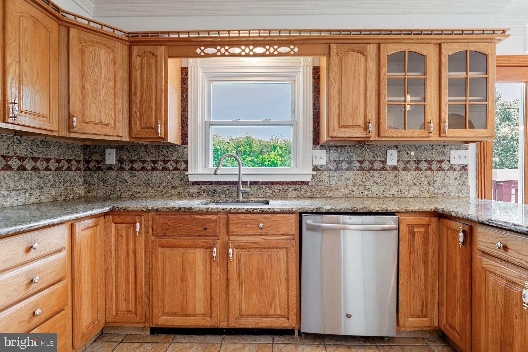 11325 Bacon Race Road Woodbridge, VA 22192 - Photo 15 of 54 a kitchen with stainless steel appliances granite countertop cabinets and window