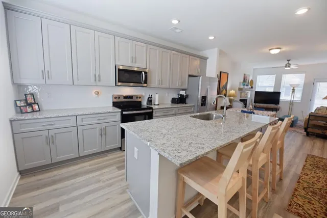 a bedroom with a bed a large window and bookshelf