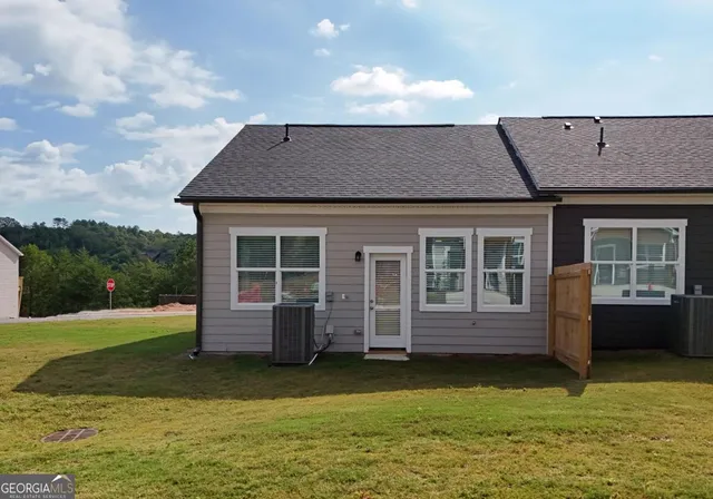 a kitchen with stainless steel appliances granite countertop a stove top oven a sink dishwasher and a refrigerator with wooden floor