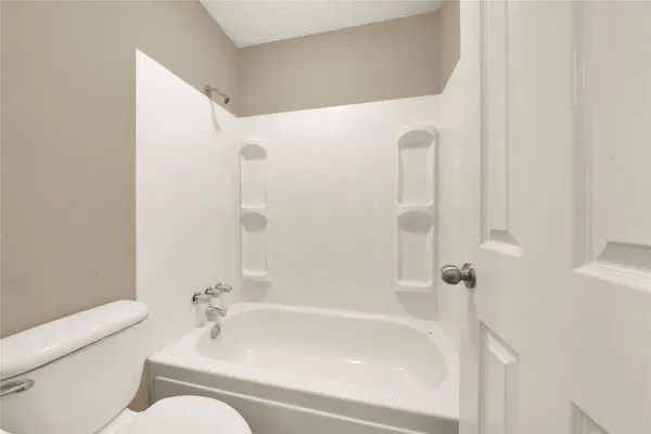 a bathroom with a bathtub and shower