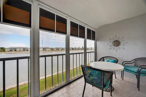 a view of a balcony with furniture and a window