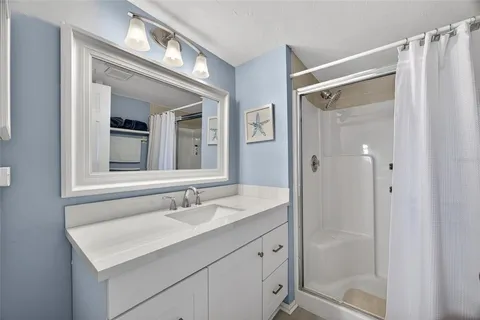 a bathroom with a sink vanity and a mirror