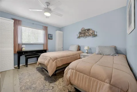 a bedroom with two beds and a window