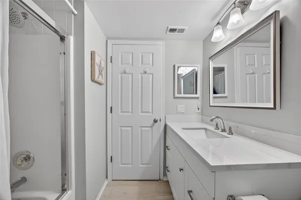 a bathroom with a sink and mirror with toilet