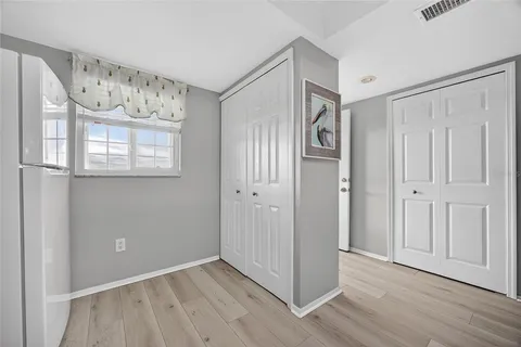 a view of an entryway with wooden floor
