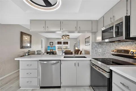 a kitchen with stainless steel appliances granite countertop a sink and cabinets