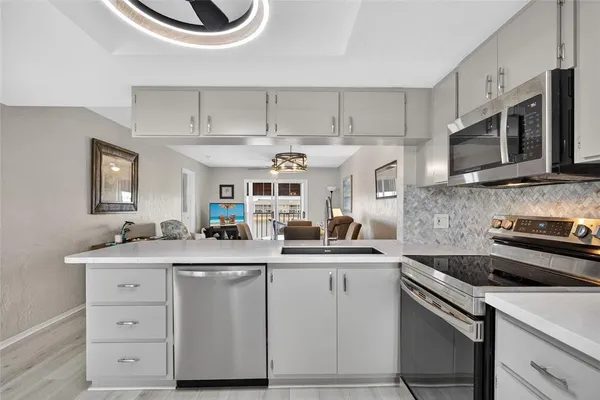a kitchen with stainless steel appliances granite countertop a sink and cabinets