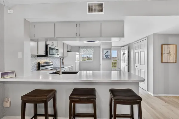 a kitchen with cabinets a counter space and a sink