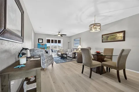 a living room with furniture wooden floor and a chandelier