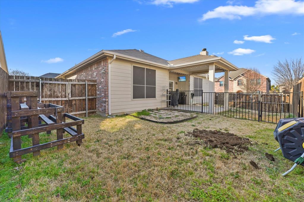 3801 Surf Street Denton, TX 76208 - Photo 26 of 29 Rear view of house with brick siding, a patio, a chimney, and a fenced backyard