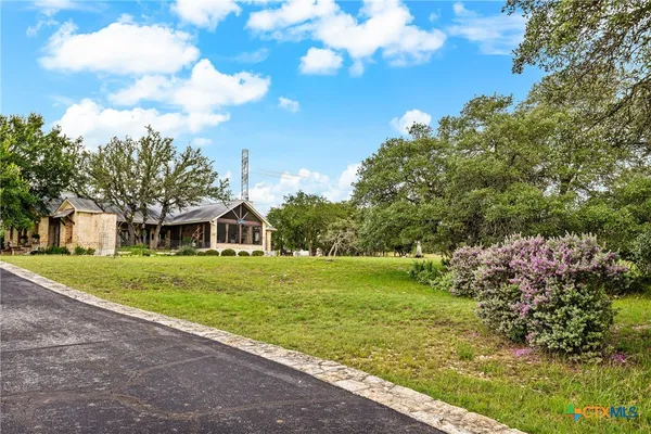 a view of a big yard with a house in the background
