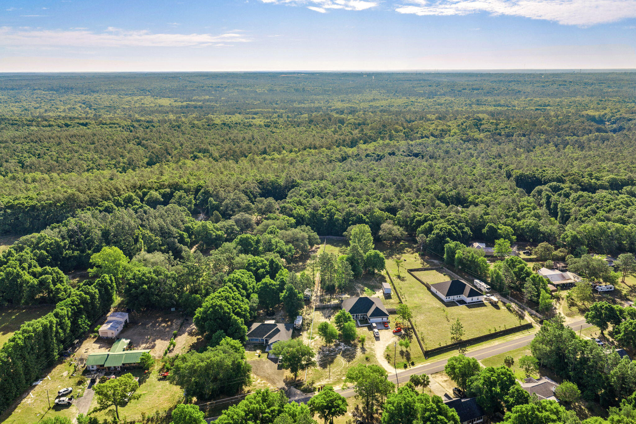 5595 Sam O'Neal Road Baker, FL 32531 - Photo 1 of 15 an aerial view of residential houses with outdoor space and trees
