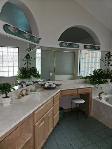 a bathroom with a double vanity sink and mirror