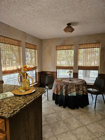 a spacious bedroom with a bed and a table in it