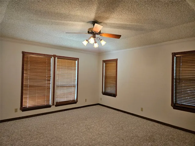 a view of a livingroom with a ceiling fan and window