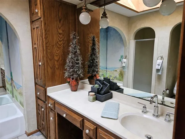 a bathroom with double vanity sinks a vanity and a mirror