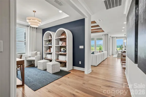 a view of living room filled with furniture and wooden floor