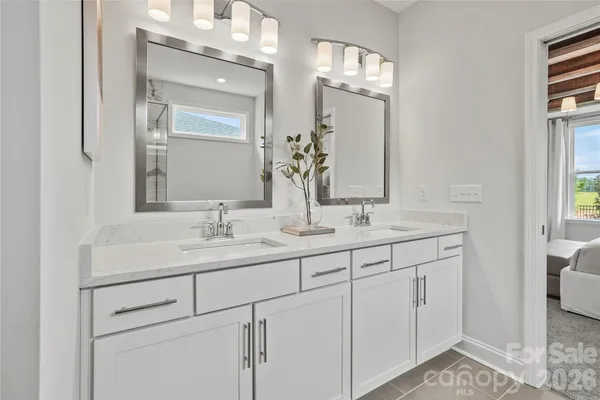 a bathroom with a double vanity sink and a mirror