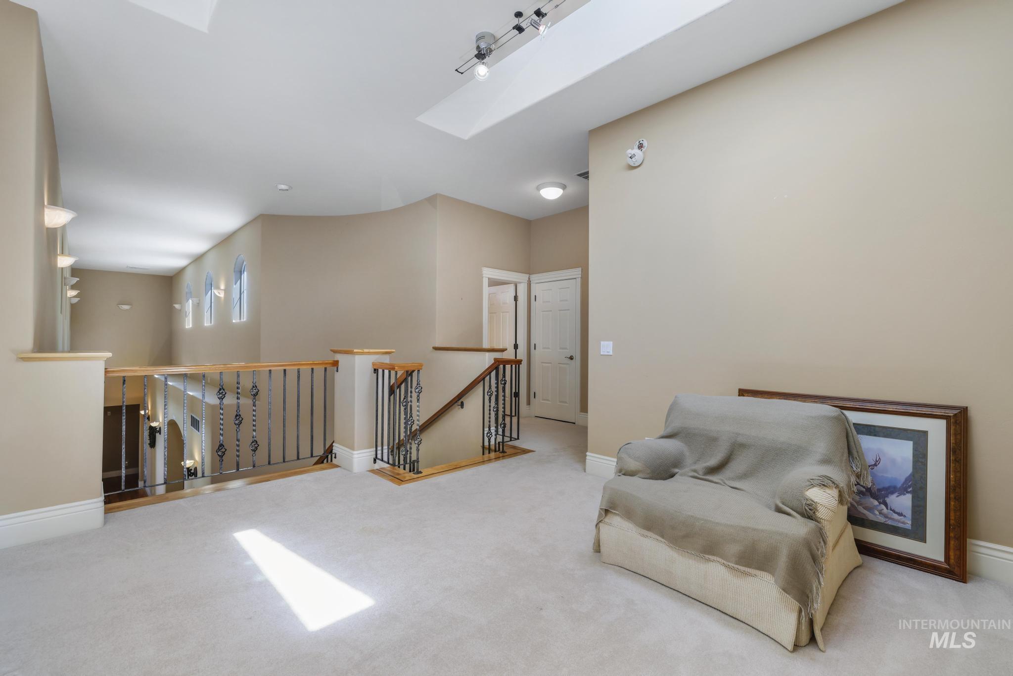 1526 Highway 26 Gooding, ID 83330 - Photo 21 of 48 Living area featuring an upstairs landing, a skylight, and carpet