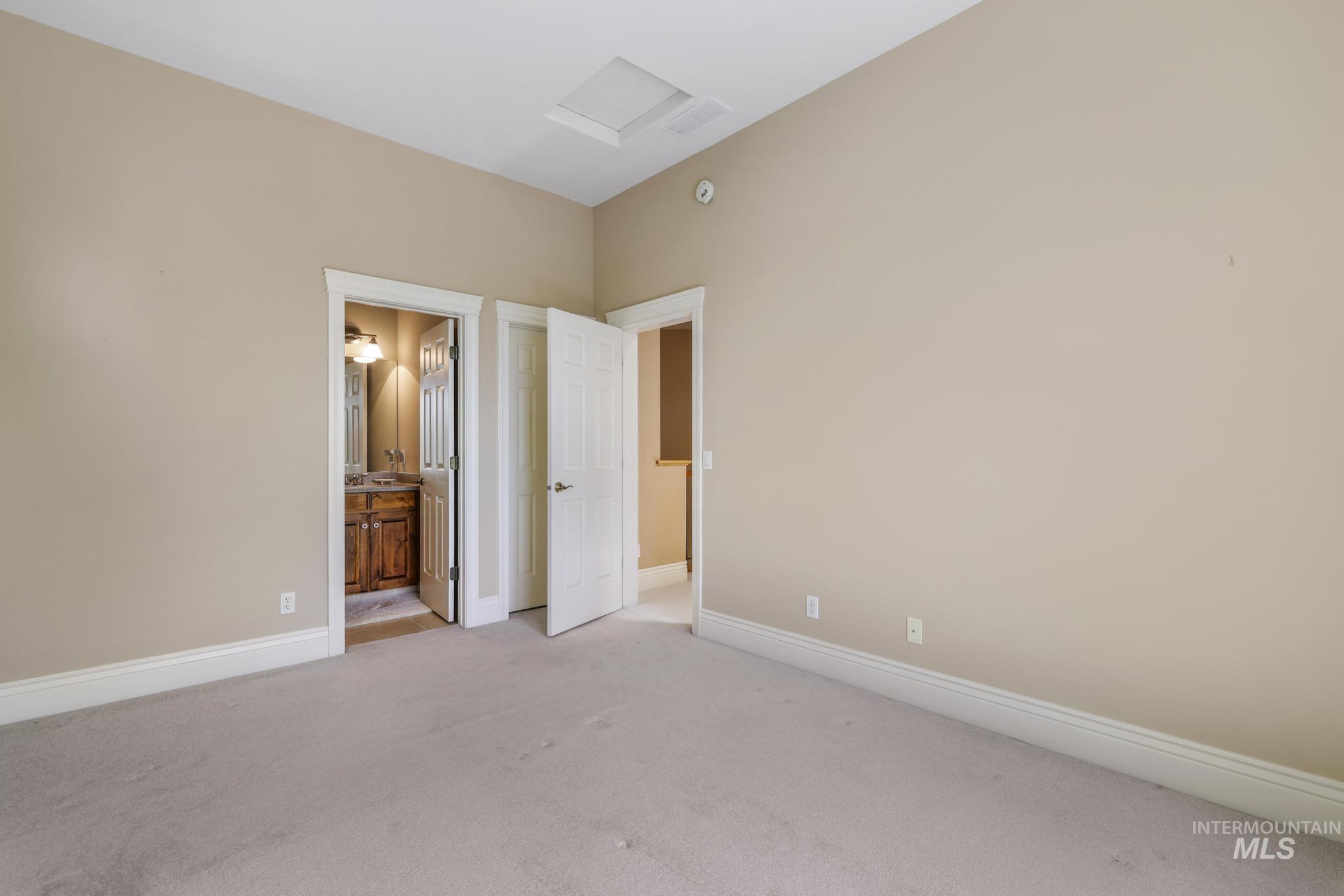 1526 Highway 26 Gooding, ID 83330 - Photo 27 of 48 Unfurnished bedroom featuring attic access, carpet flooring, and ensuite bath