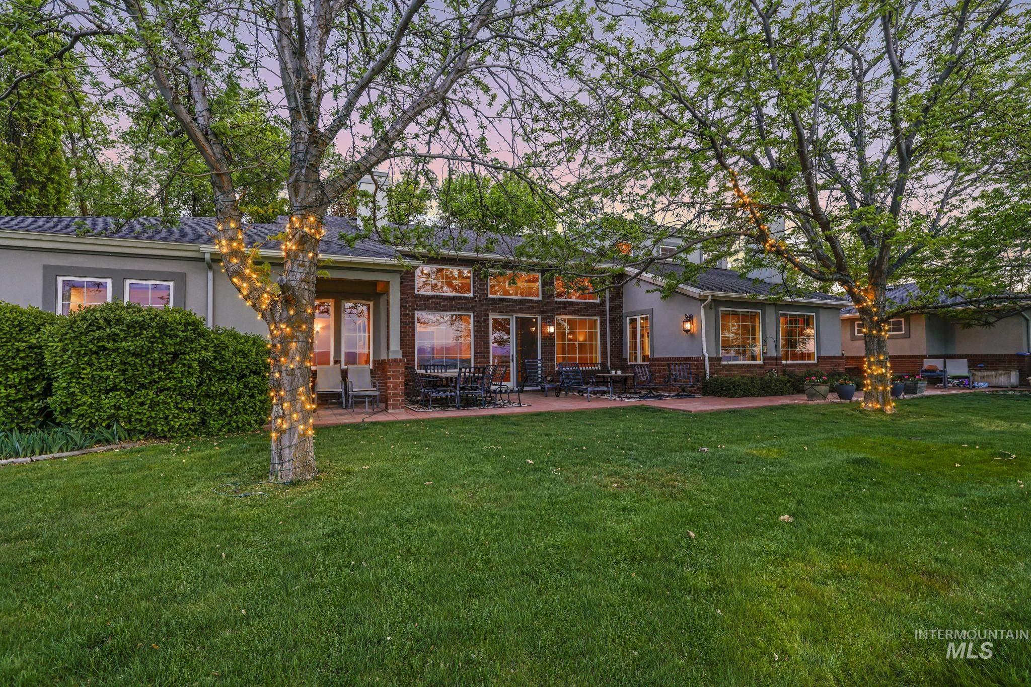 1526 Highway 26 Gooding, ID 83330 - Photo 35 of 48 Rear view of house with brick siding, a yard, a patio, and stucco siding