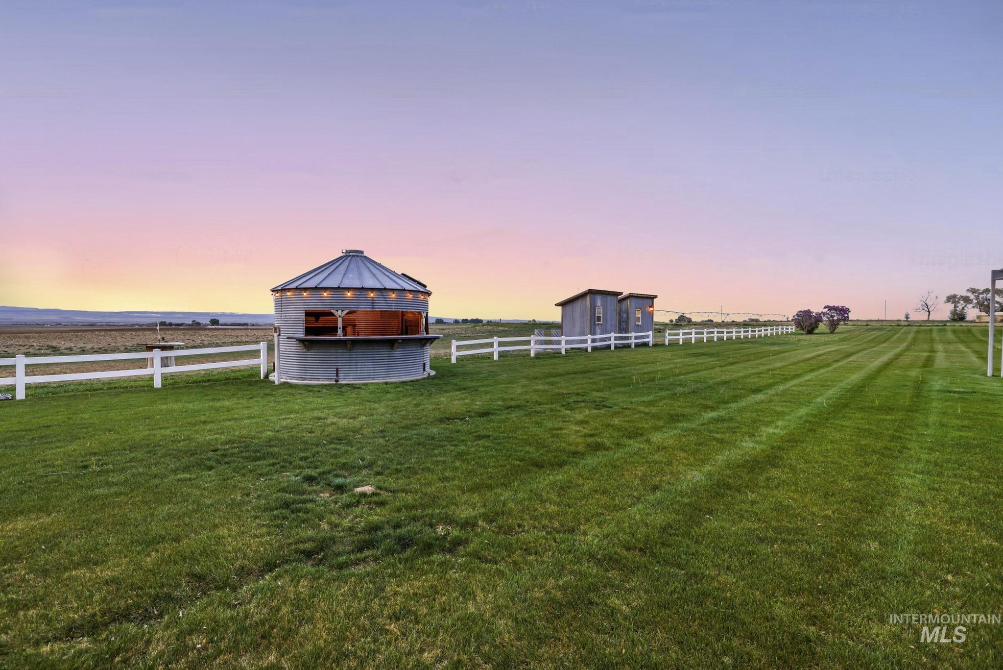 1526 Highway 26 Gooding, ID 83330 - Photo 39 of 48 Yard at dusk featuring a gazebo, an outbuilding, and a view of rural / pastoral area