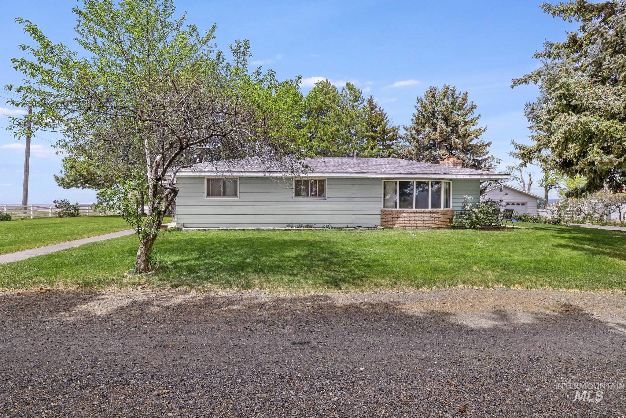 1526 Highway 26 Gooding, ID 83330 - Photo 46 of 48 Ranch-style house featuring a front yard, a chimney, and a sunroom