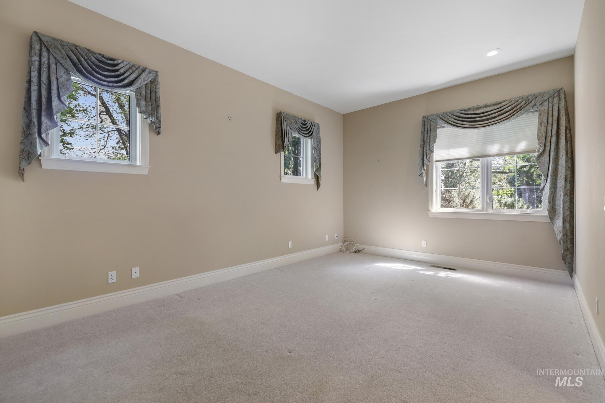 1526 Highway 26 Gooding, ID 83330 - Photo 9 of 48 Carpeted empty room featuring healthy amount of natural light