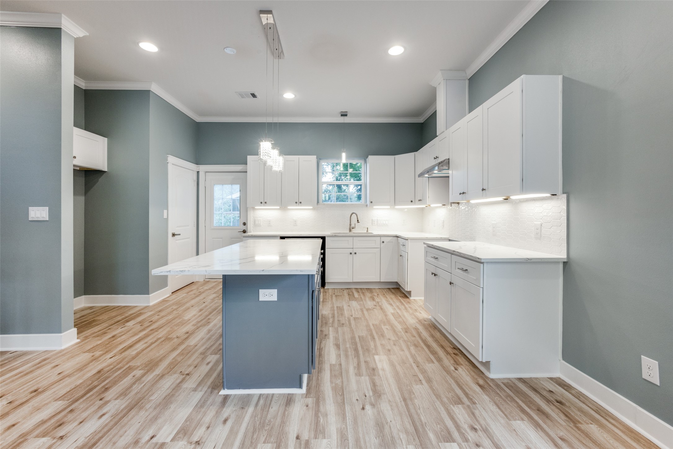 4927 East Ridge Creek Drive Houston, TX 77053 - Photo 7 of 25 a kitchen with kitchen island a sink white cabinets and stainless steel appliances