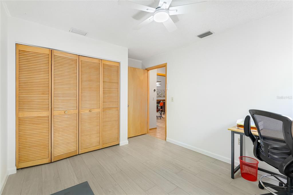 4537 South Lockwood Ridge Road Sarasota, FL 34231 - Photo 19 of 22 a view of room with workspace and chandelier
