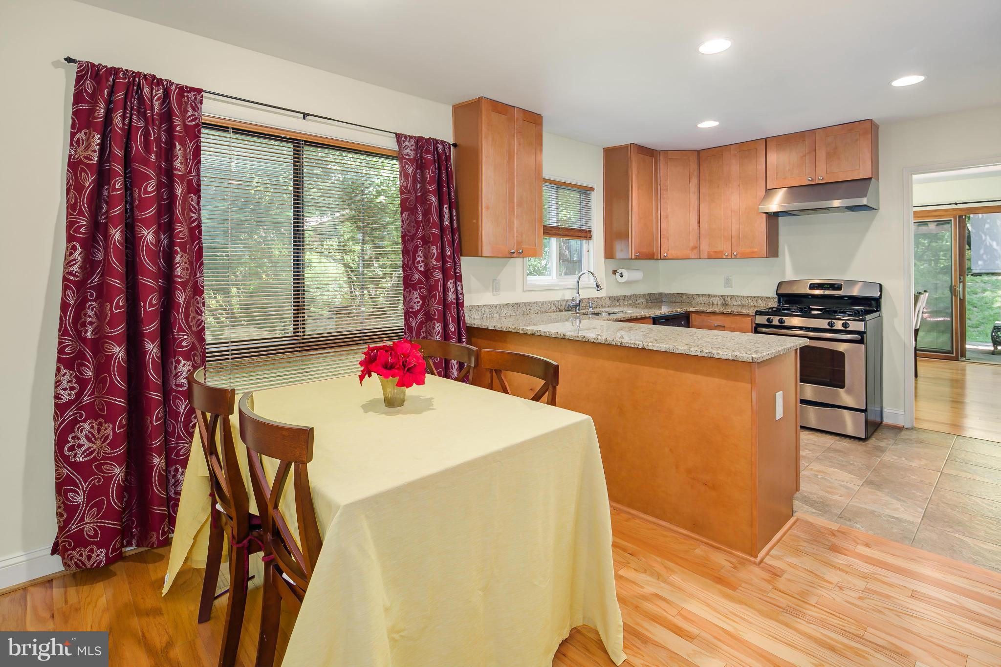 2309 November Lane Reston, VA 20191 - Photo 11 of 29 a kitchen with stainless steel appliances kitchen island granite countertop a stove a sink and a refrigerator