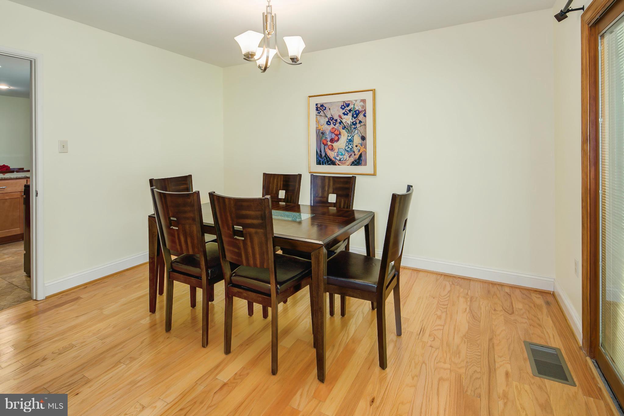 2309 November Lane Reston, VA 20191 - Photo 7 of 29 a view of a dining room with furniture and wooden floor