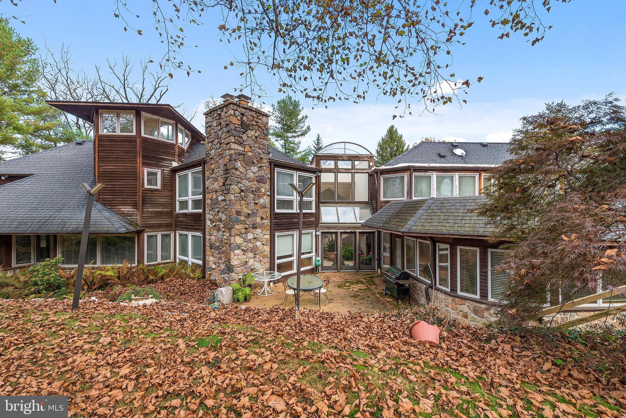 front view of a house with a large tree